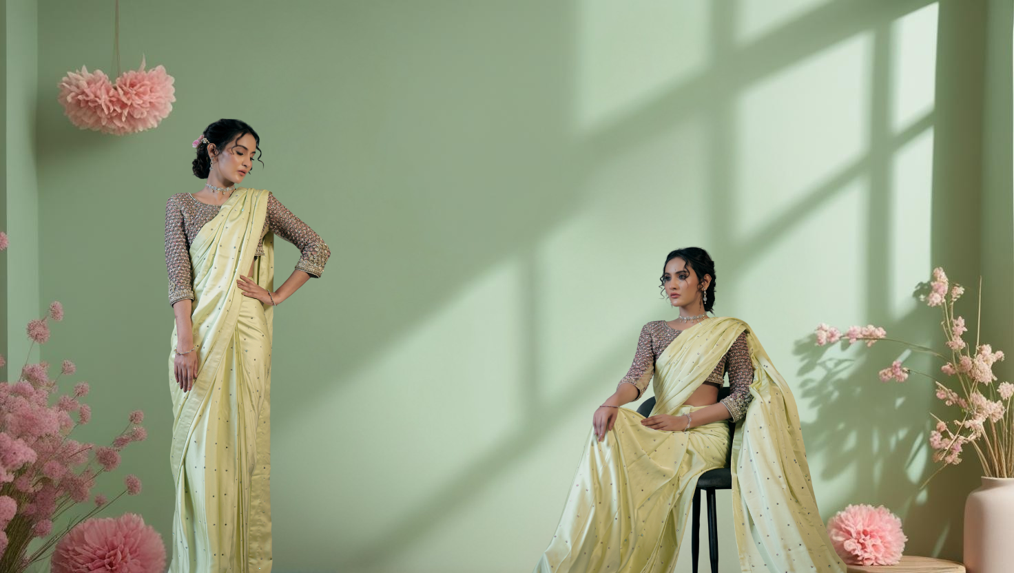 Indian models wearing elegant ethnic suits with soft background in pastel green and golden tones, perfect for global clients